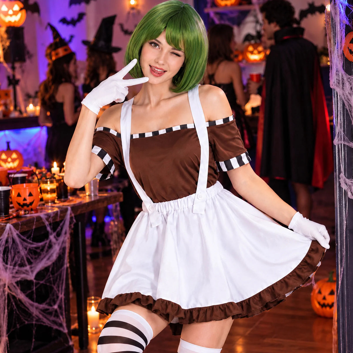 A woman in the factory worker costume inspired by Oompa Loompas poses with white gloves beside Halloween decorations at a party.