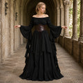 Woman wearing a black medieval dress with brown lace-up waist cincher in a stone cloister
