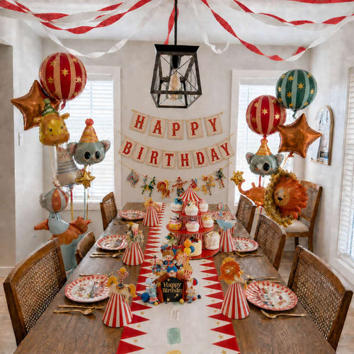 colorful circus party table decoration with balloons banners plates and hats for kids birthday celebration
