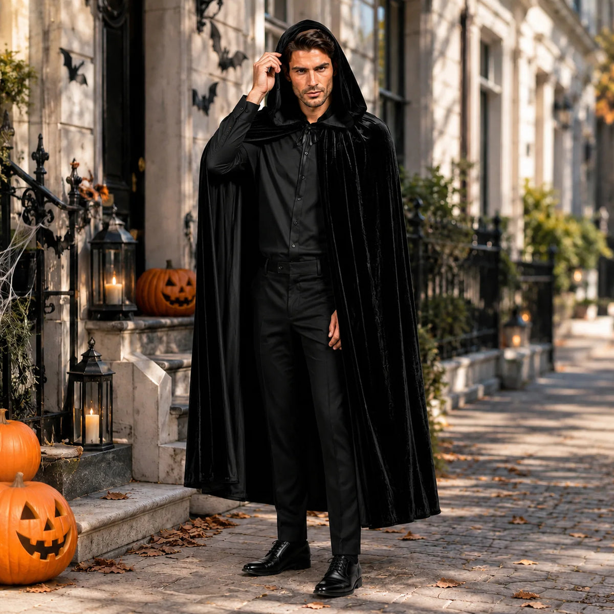Adult black hooded vampire cape styled in an outdoor Halloween setting.