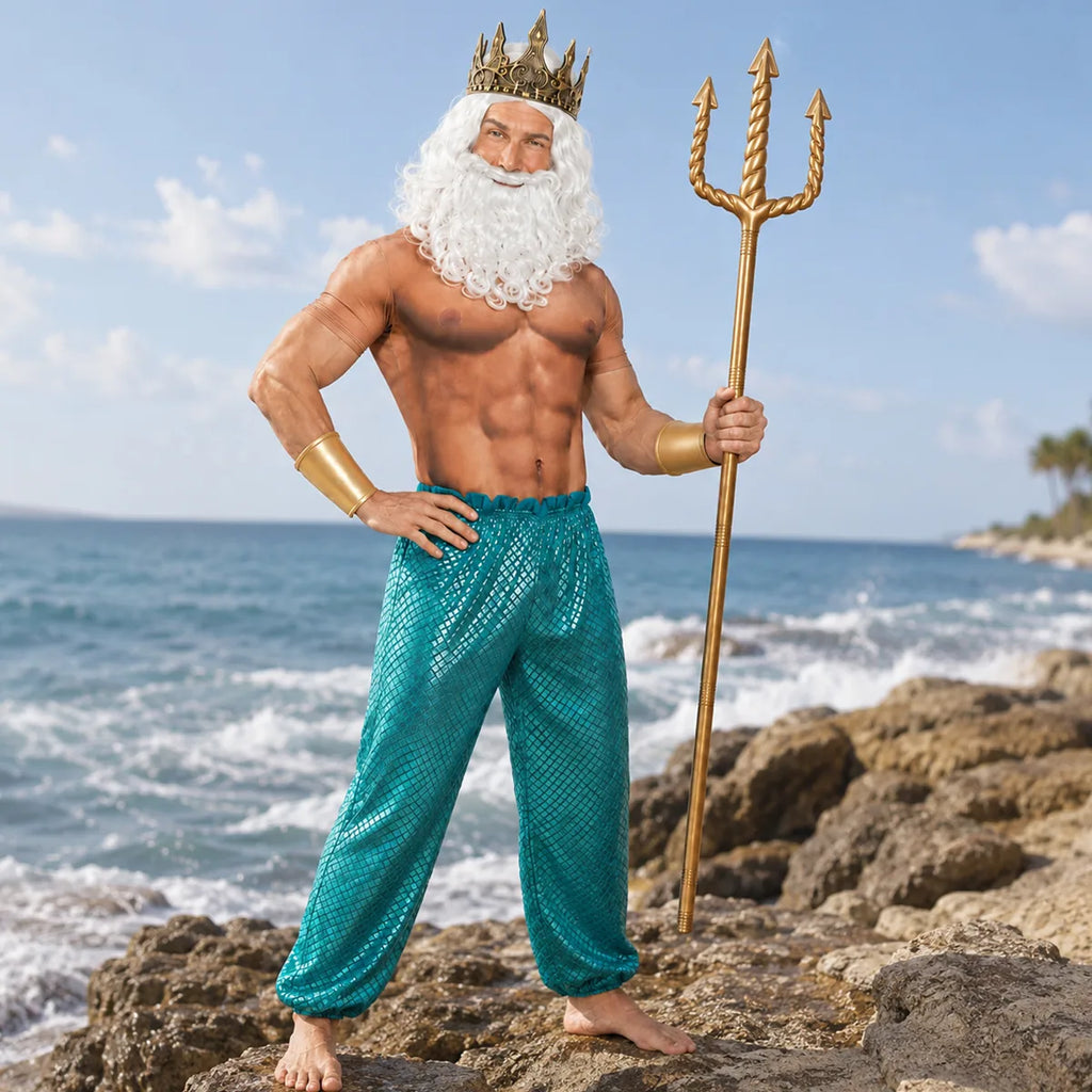 Adult ocean king costume posed by the sea with gold trident