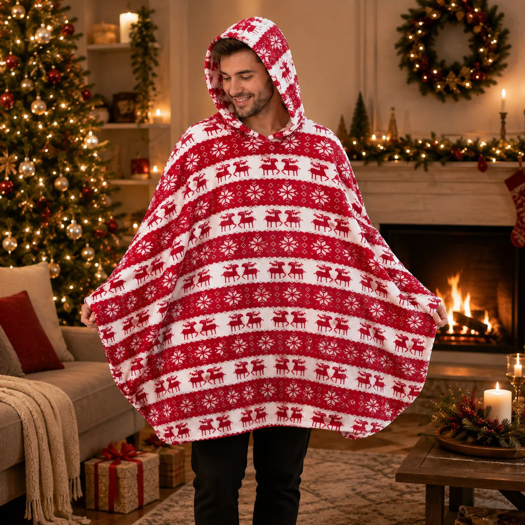 Man wearing red Christmas blanket poncho by fireplace