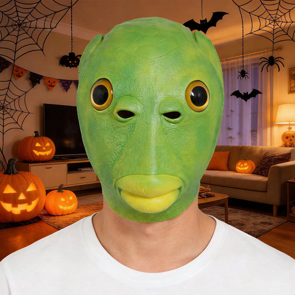 An adult wears a funny green fish head mask for a Halloween costume, with the oversized eyes, fish-scale texture and full-head shape clearly visible.