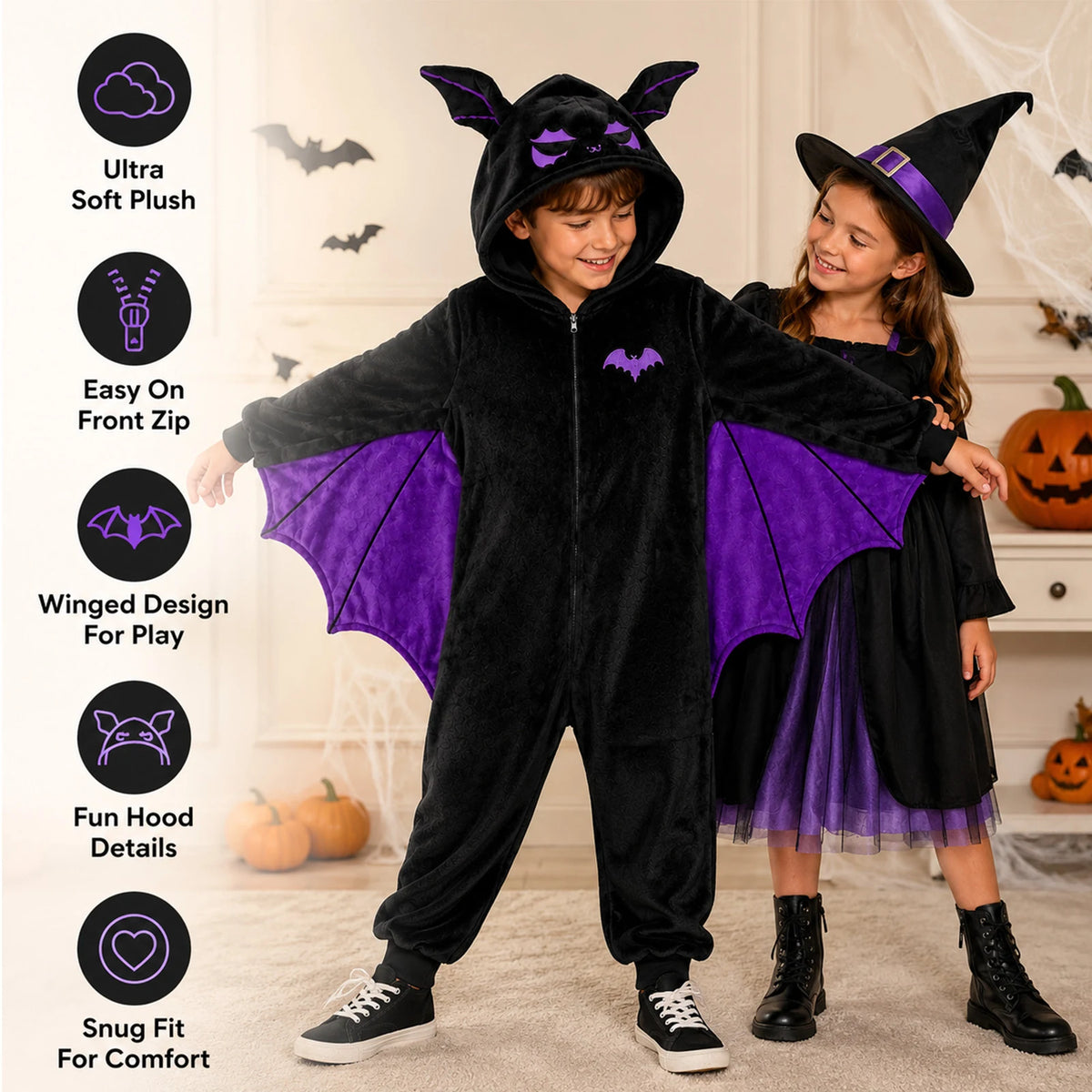 Child wearing a black bat-wing onesie with purple wings beside a witch-costumed companion; feature infographic highlights the hood, zipper, plush fabric and wings.