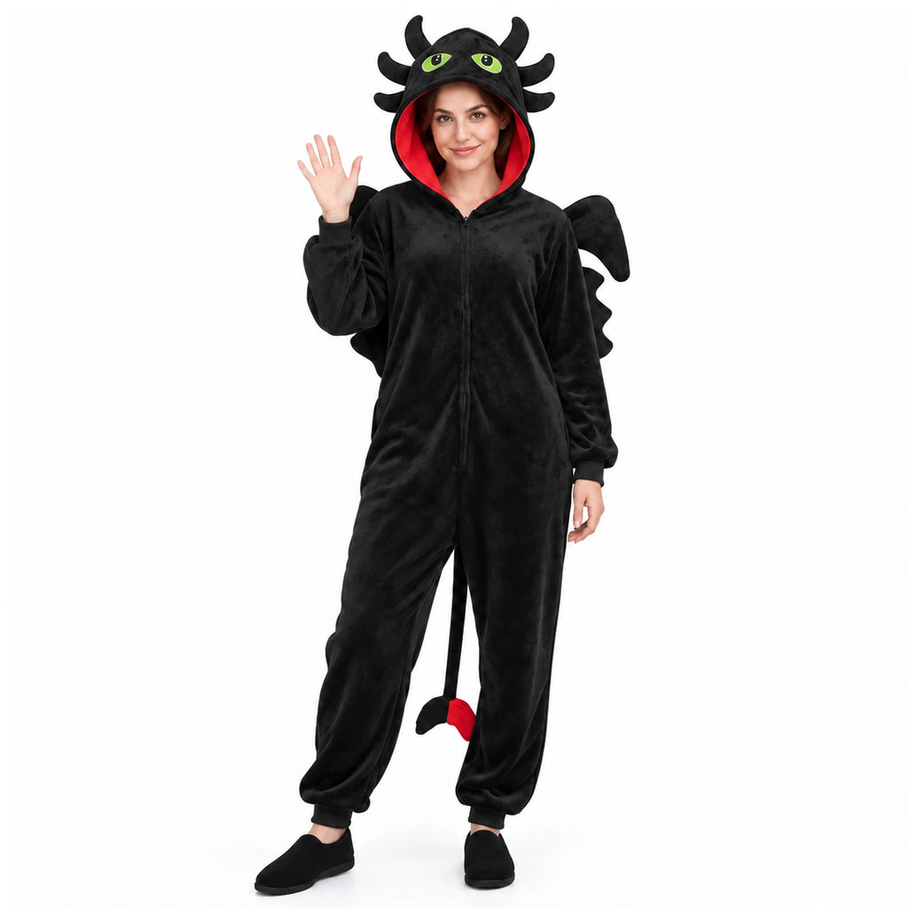 Full-length view of a waving model in the Toothless-inspired black dragon onesie with wings and tail.
