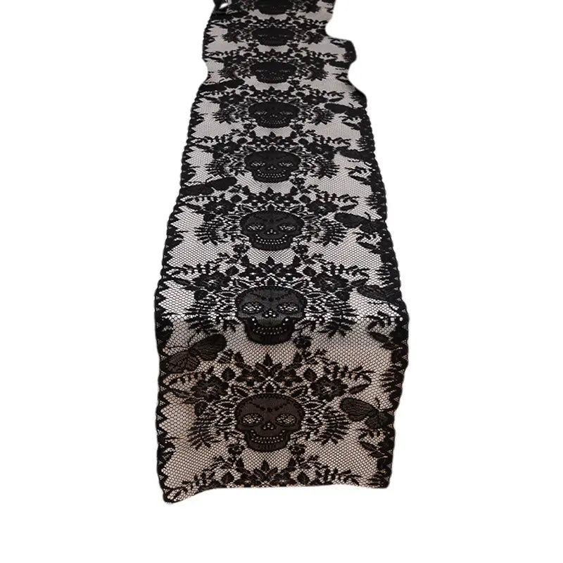 Black lace Halloween table runner with skull design shown as a standalone product image on a plain background.
