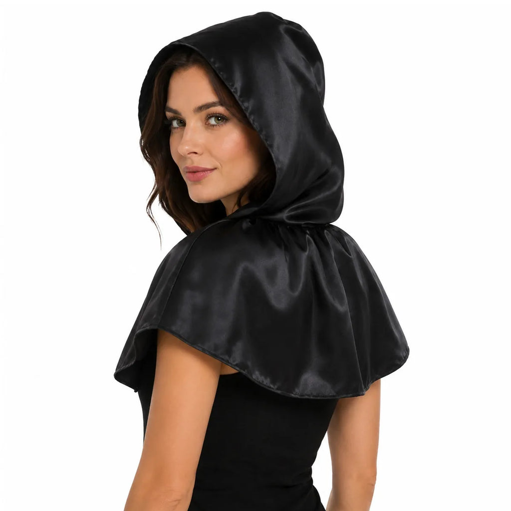 Side view of the black satin hooded capelet worn, showing its profile and visible construction details.