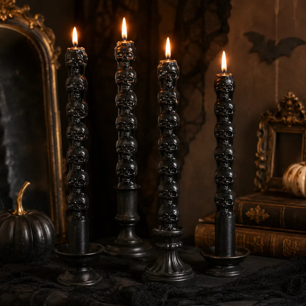 Black skull-shaped candles burning in a dark gothic Halloween scene with vintage books, pumpkins, mirrors, and lace decor