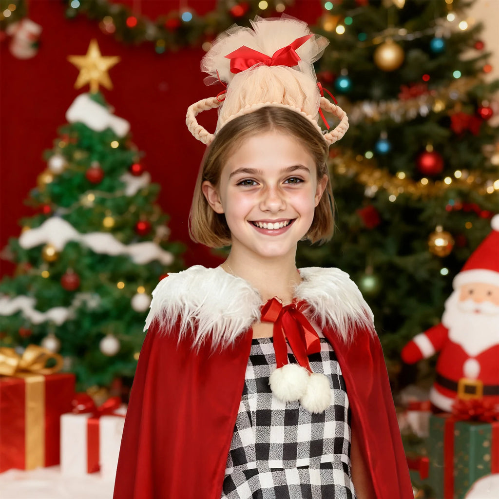 A girl wears the blonde updo headband beside a decorated Christmas tree.