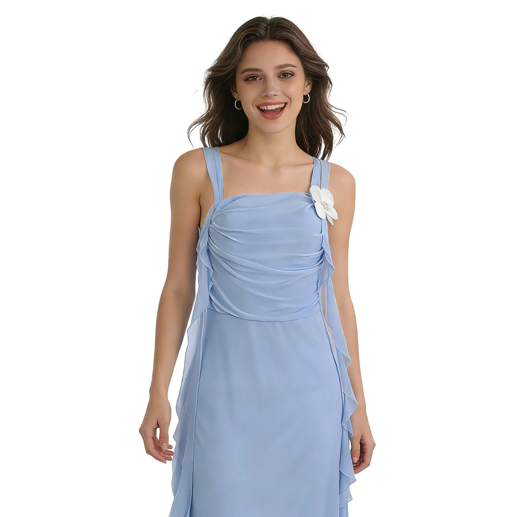A woman models the blue daisy ribbon maxi dress in a closer waist-up front pose against a white background.