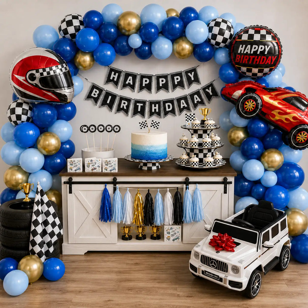 Blue and gold race car balloon garland above a dessert table with checkered cupcakes and racing balloons