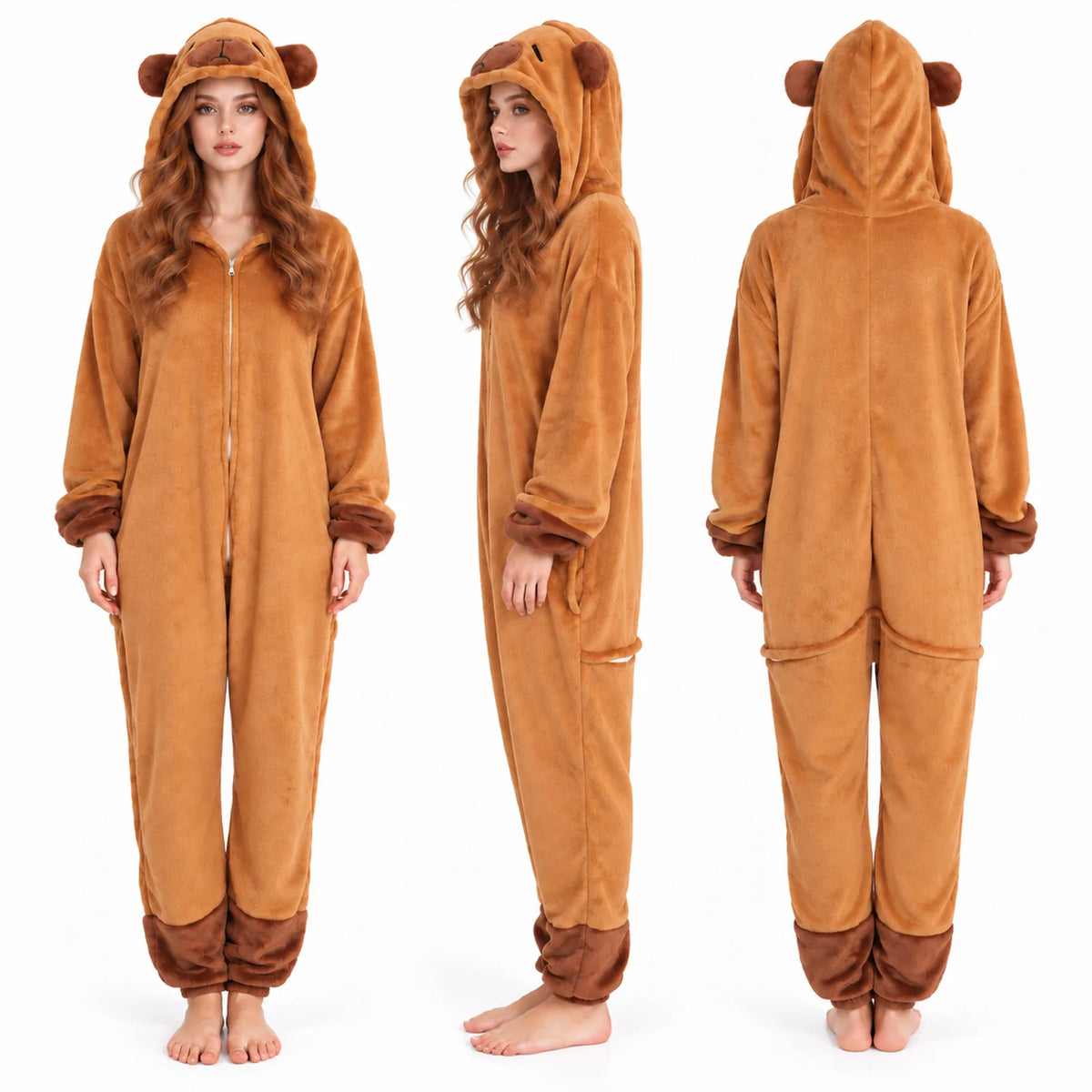 Three views of the brown capybara onesie on a model show the front zipper, side profile, and back with the hood's embroidered face.