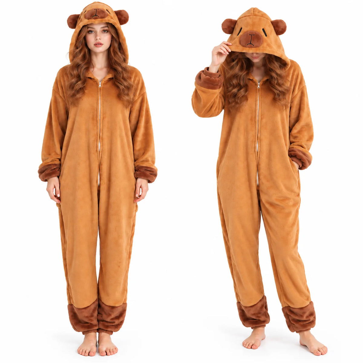 A woman wears the brown capybara onesie with the hood up, showing the embroidered capybara face, ears, front zipper, and dark brown cuffs.