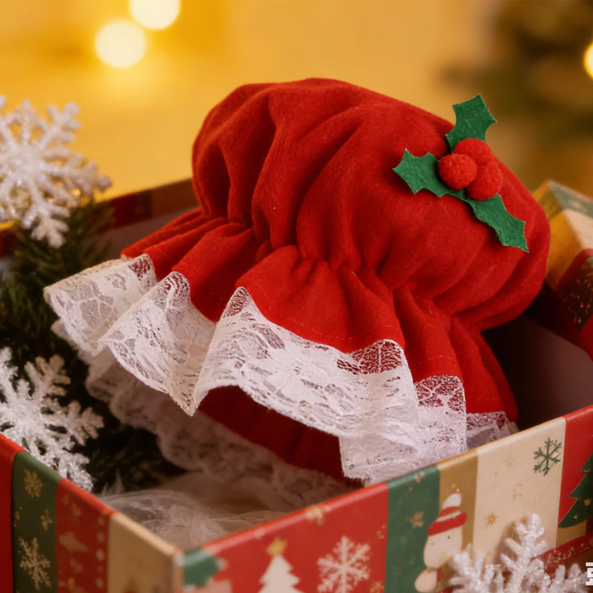 A close-up shows the red bonnet and white lace in a gift box.