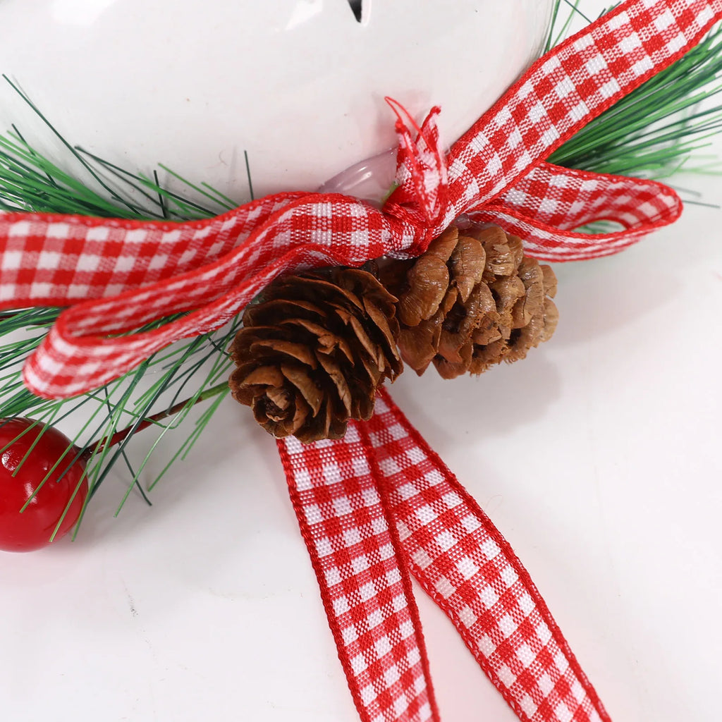 Close-up of the gingham ribbon bow and pine cones on the White Christmas bell ornament