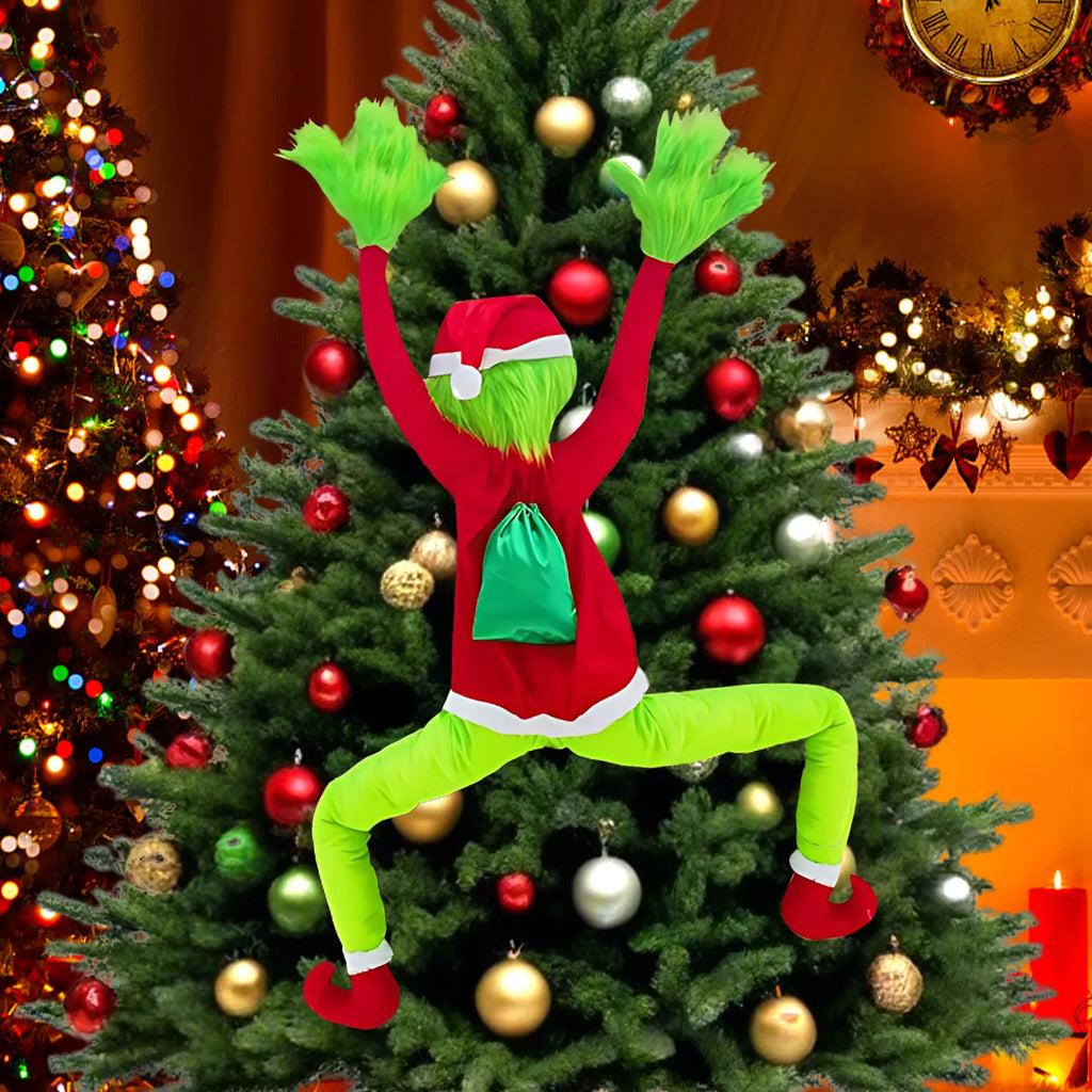 Green furry climbing Christmas character decoration (Inspired by the Grinch) with legs spread climbing a Christmas tree full of ornaments
