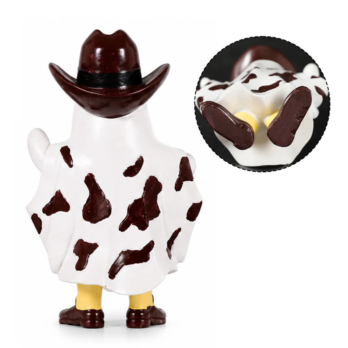 Back view of the cowboy ghost figurine shows the glossy brown hat, cow-print pattern, and stable base.