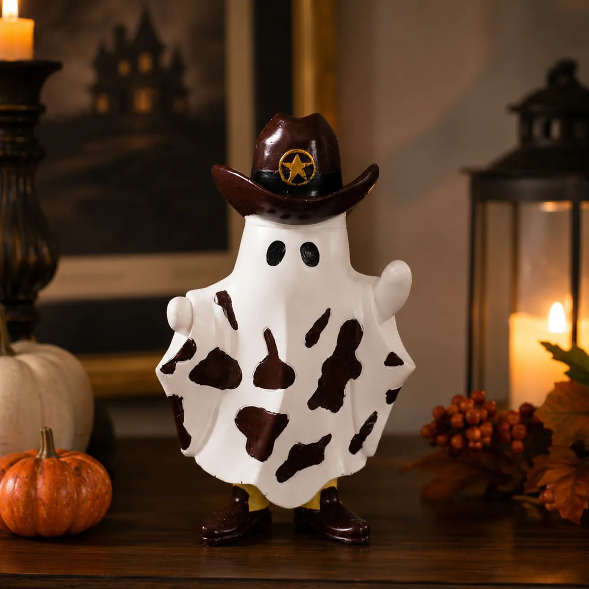 Cowboy ghost figurine displayed beside pumpkins and warm lantern light.