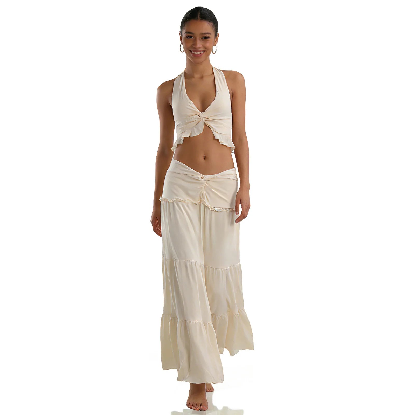 A woman models the cream halter top and maxi skirt set from the front against a white background, showing its overall silhouette.