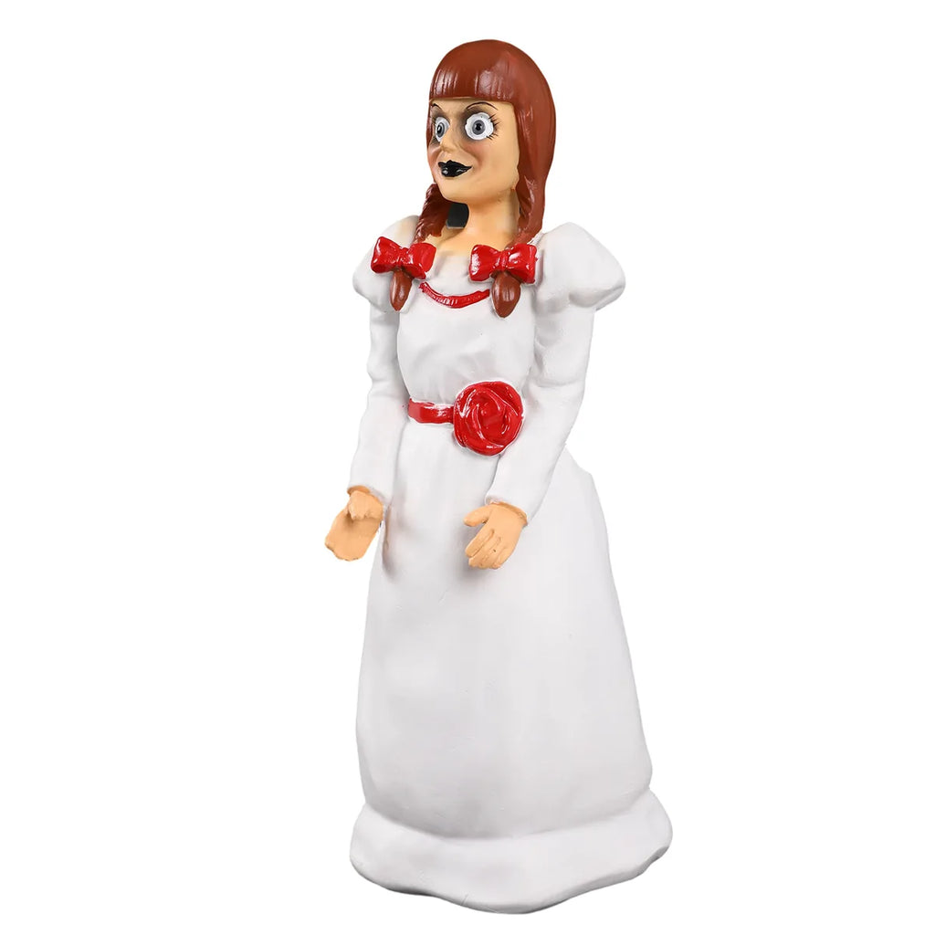 Three-quarter view shows the doll face, red bows, and white dress.