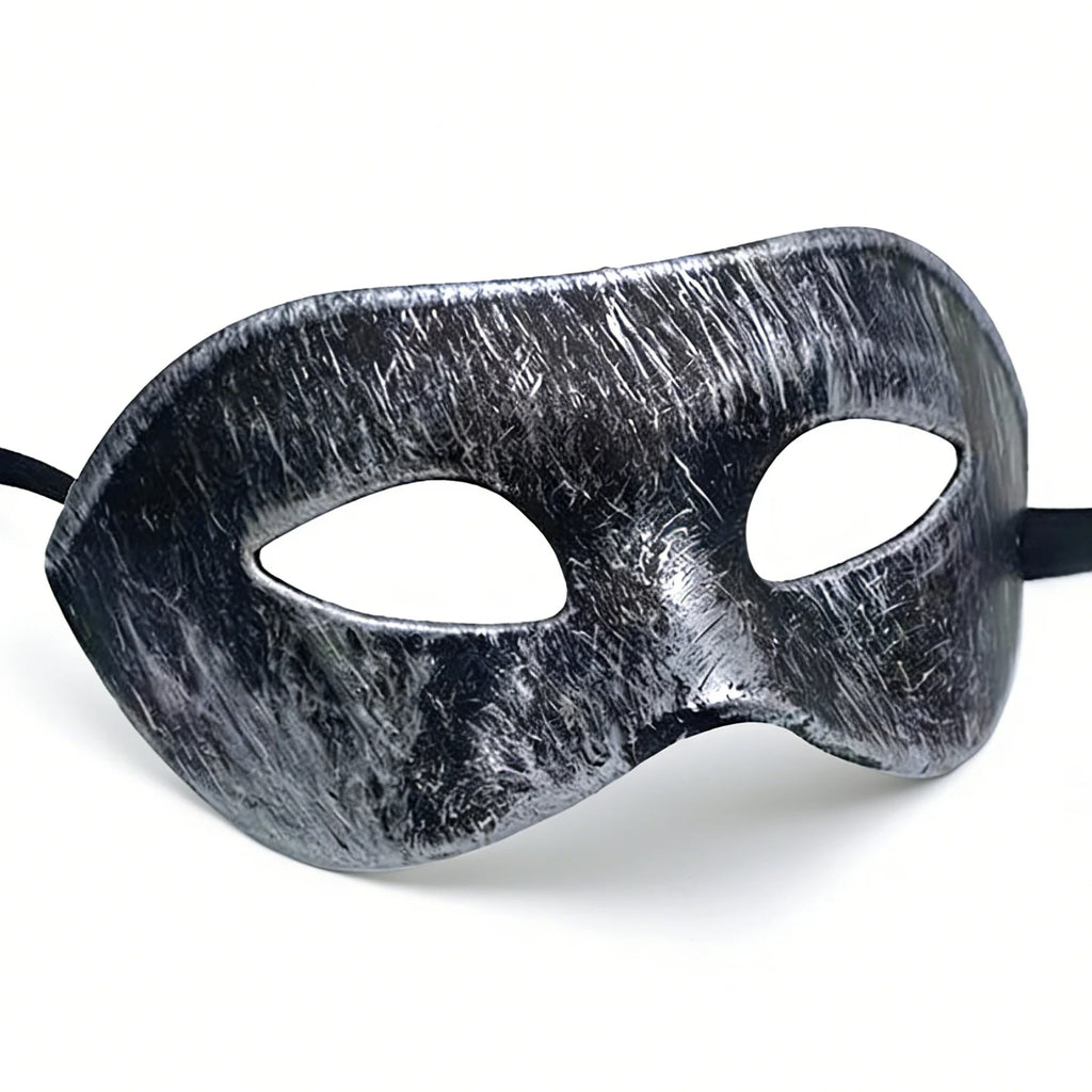 Distressed silver-black masquerade eye mask is shown from the front, with the sculpted eye shape and adjustable black ribbon tie clearly visible.