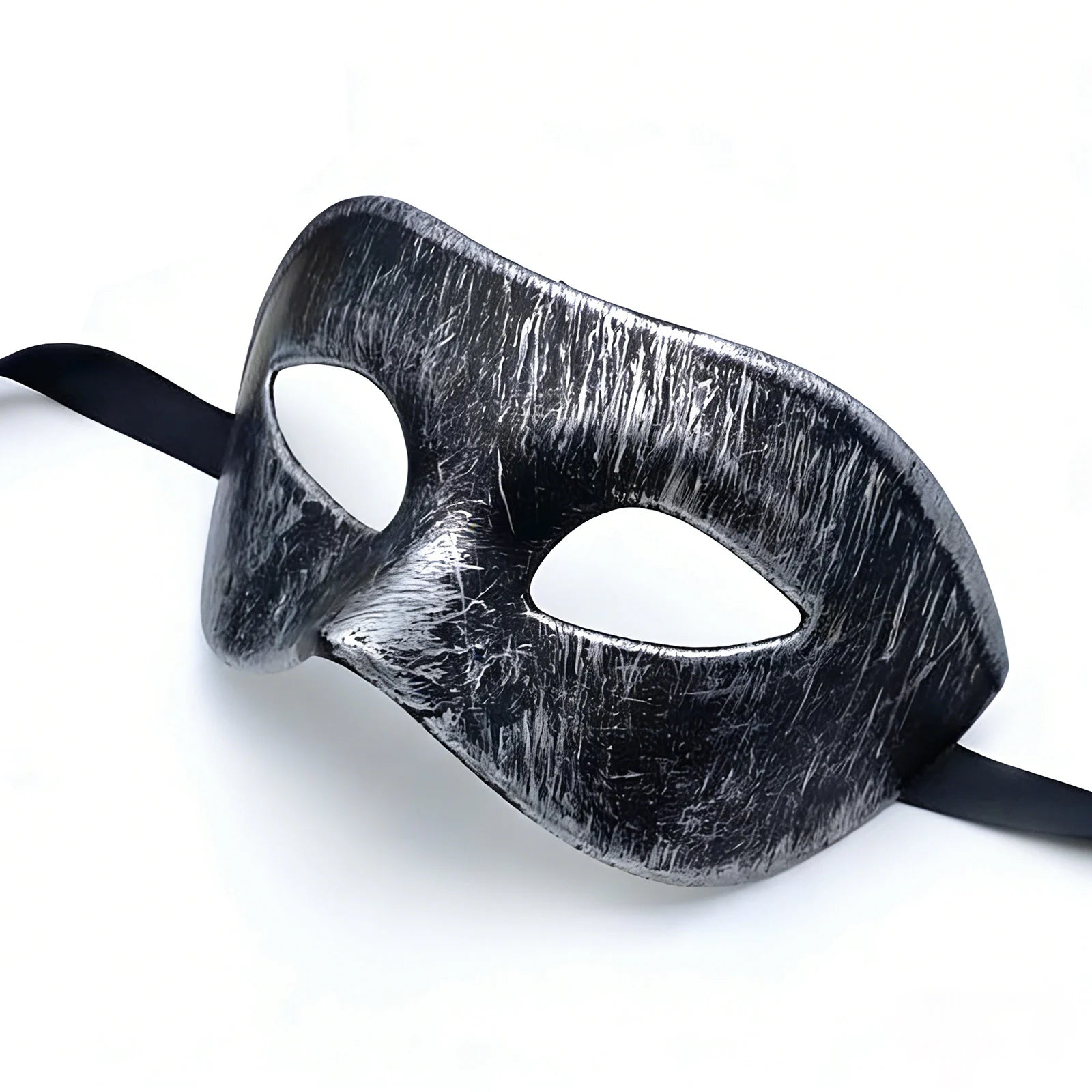 The distressed silver-black masquerade eye mask is shown from a low side angle, highlighting its sculpted shape and brushed finish.