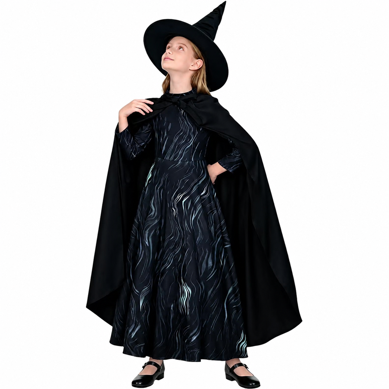 Girl posing in a black witch costume with long printed dress, cape, and pointed hat for Halloween, themed parties, and dress-up play.