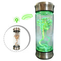 A clear product view presents a glowing alien specimen jar light with green illumination, with the clear specimen jar, sculpted alien creature and green illumination clearly visible.