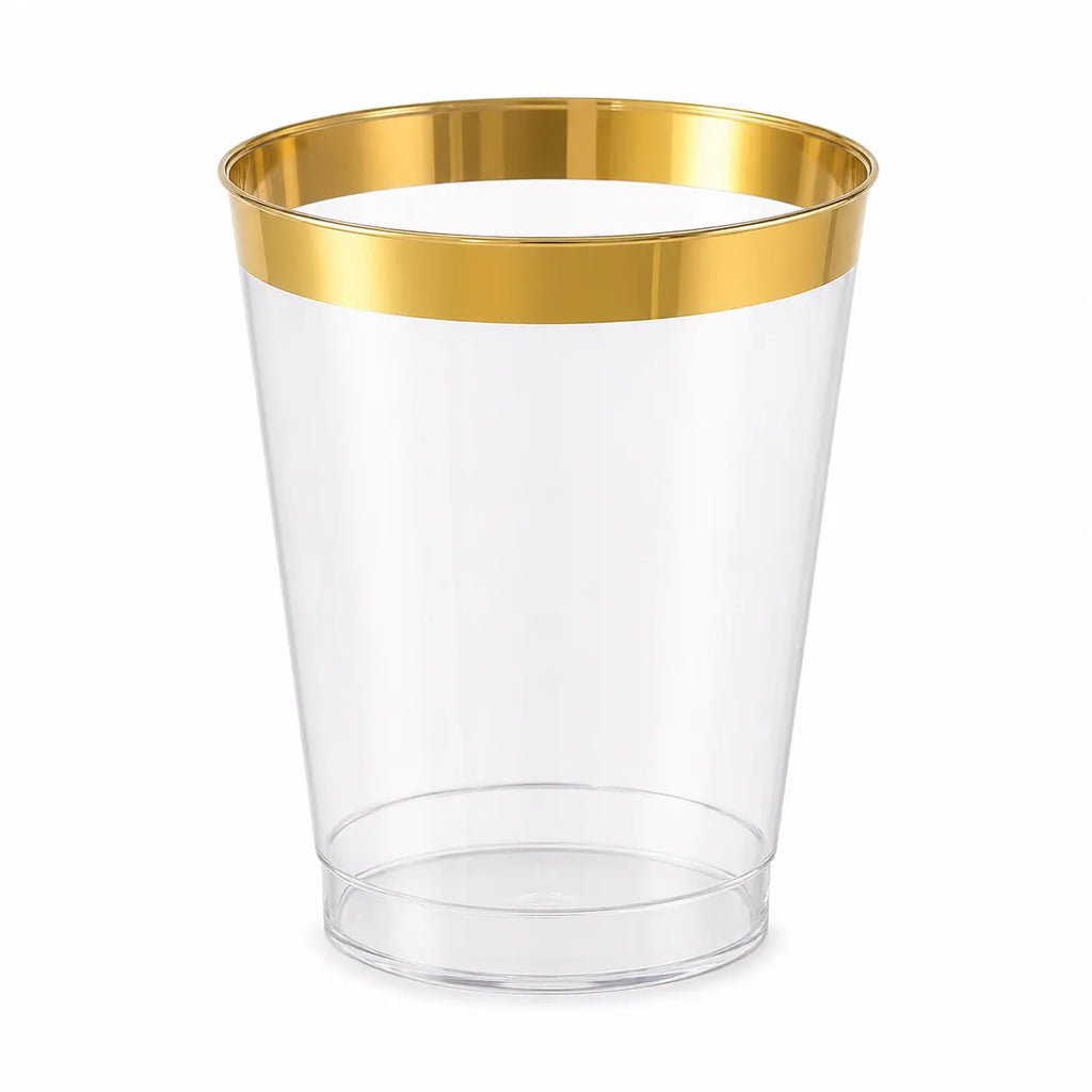 Single clear plastic cup with metallic gold rim, isolated on white background