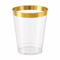 Single clear plastic cup with metallic gold rim, isolated on white background