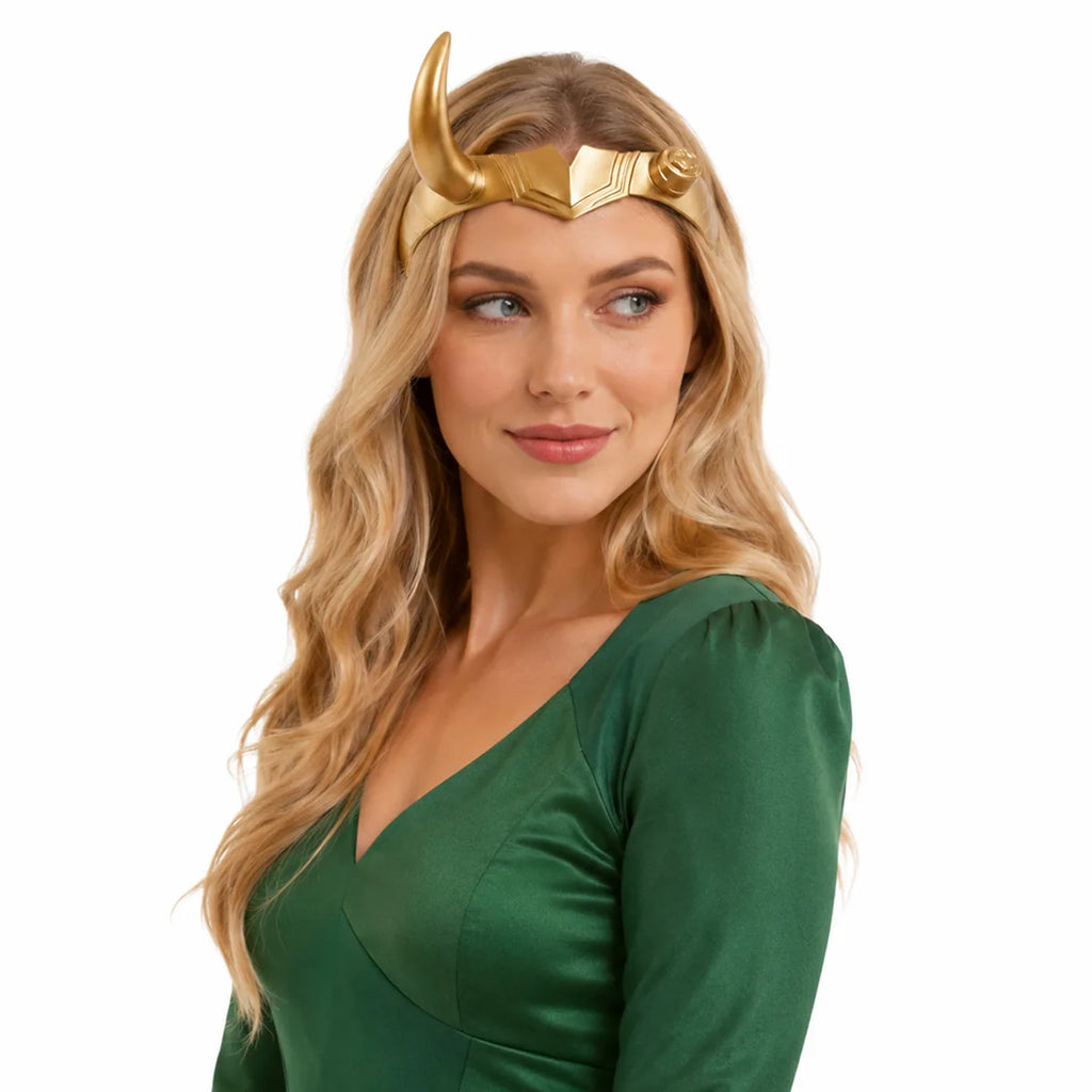 Woman wears the gold single-horn headpiece with a green costume.