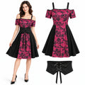 Front view of a woman wearing a red and black gothic floral dress with a black lace-up corset belt.