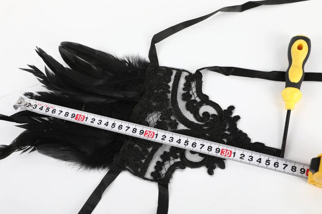 Tape measure shows the overall length of the gothic lace feather wrist cuffs.