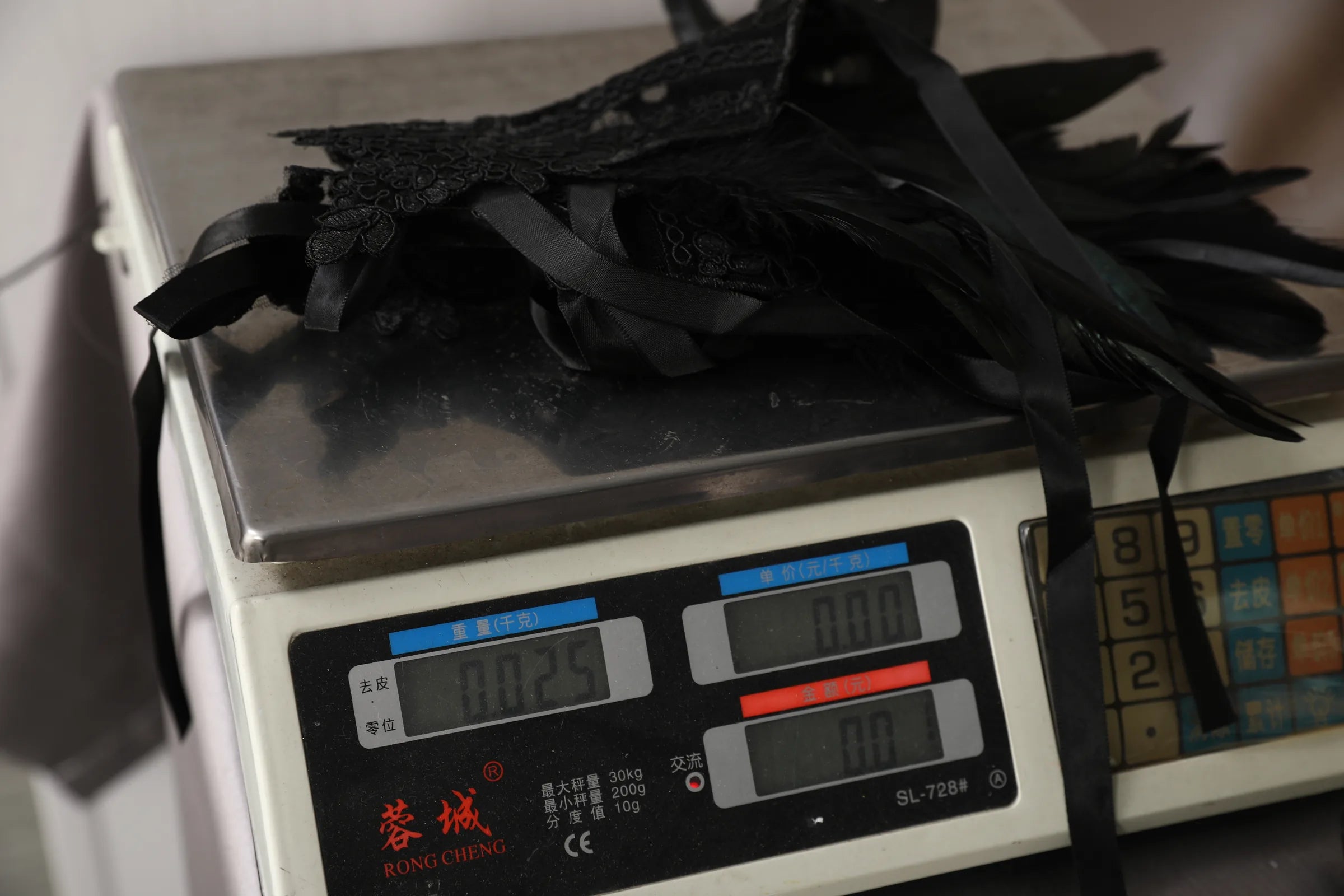 Scale display shows the measured weight of the gothic lace feather wrist cuffs.