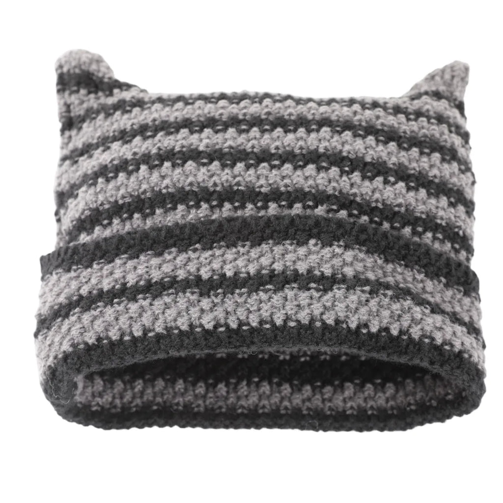 Gray and black striped knit hat with two pointed horn-like corners.