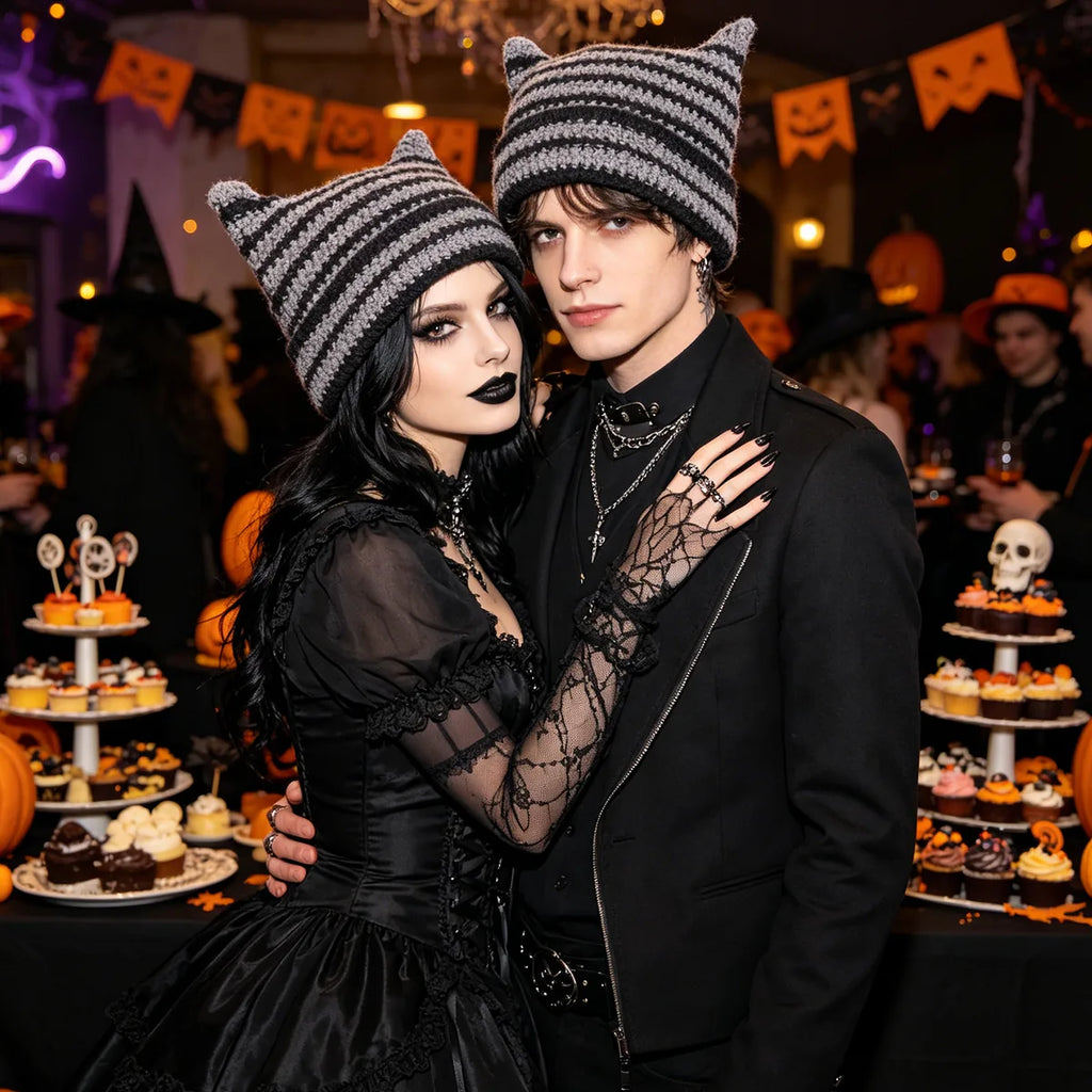 Two adults wear the striped horn knit hat at a Halloween party.