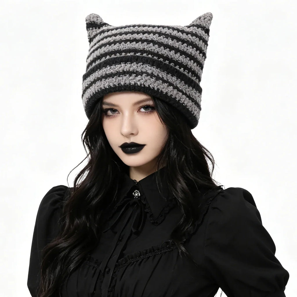 Adult wears the gray and black striped horn knit hat.