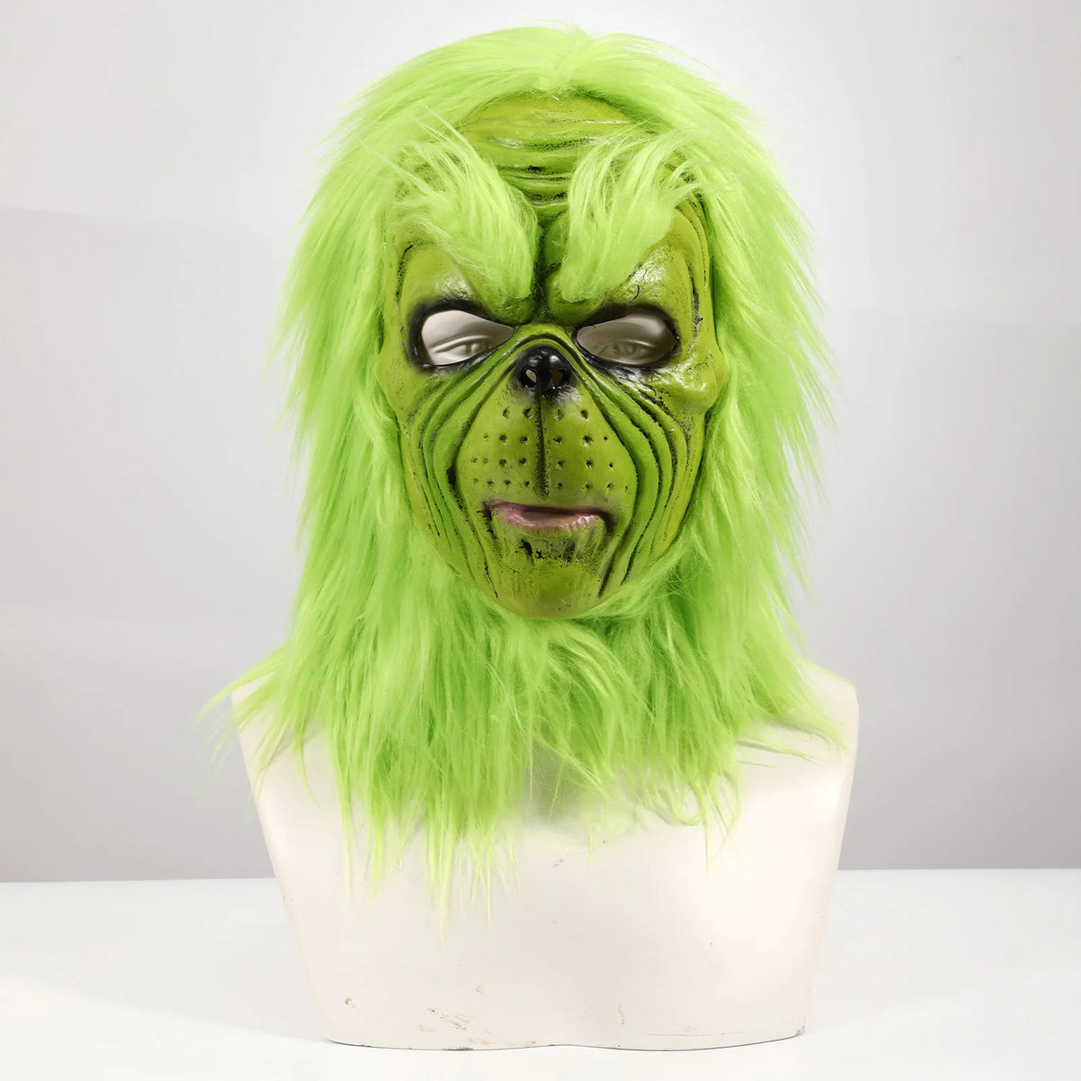 An isolated front view shows the green mask with black nose and long hair.