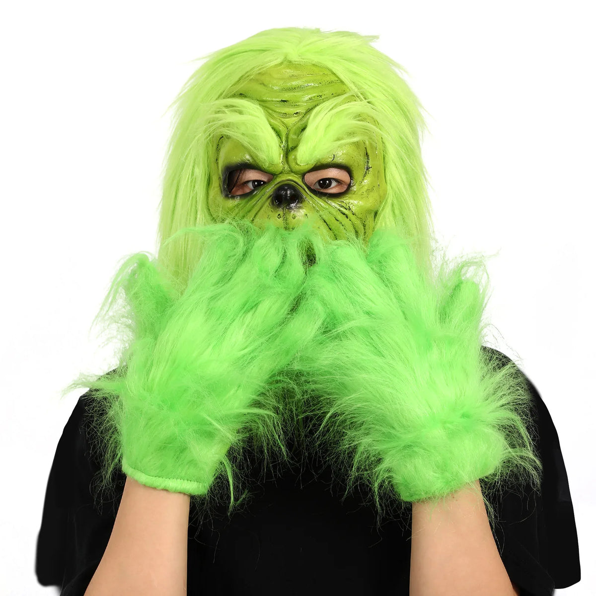 Two separate green gloves frame the face of the worn green character mask.