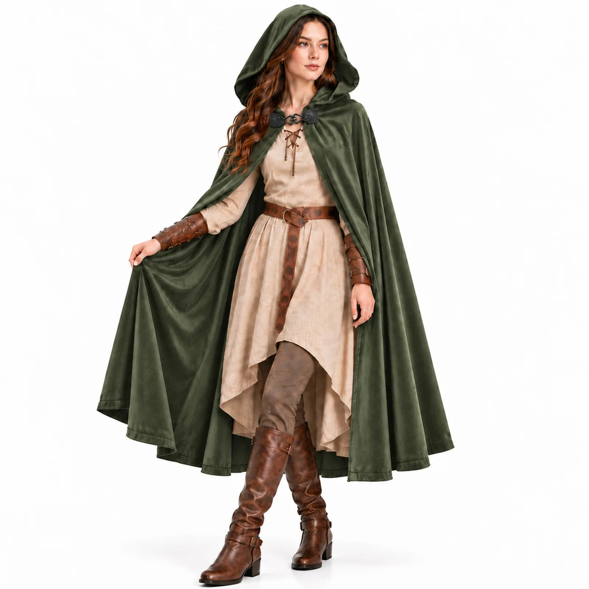 A woman in a green hooded cloak walks forward, lifting one side of the cloak to show its flowing drape.