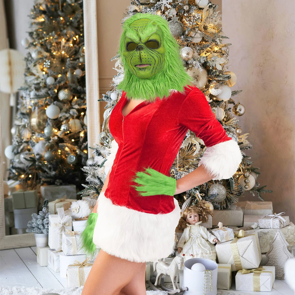A model wears the green mask with one gloved hand at the waist near a mirror.