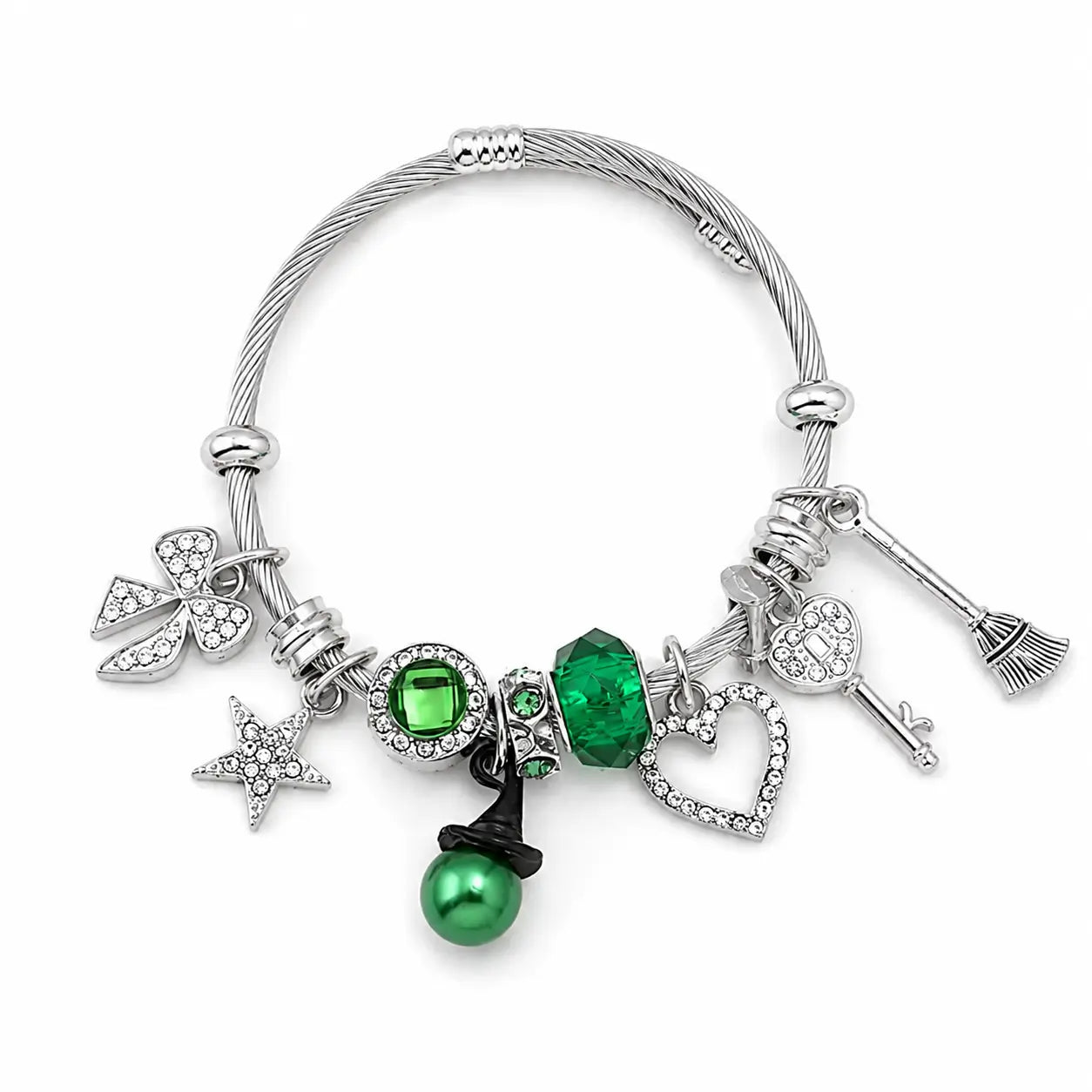 Green and silver witch charm bracelet with heart, star, bow, key, broom, witch hat, green bead, and rhinestone charms on a white background.