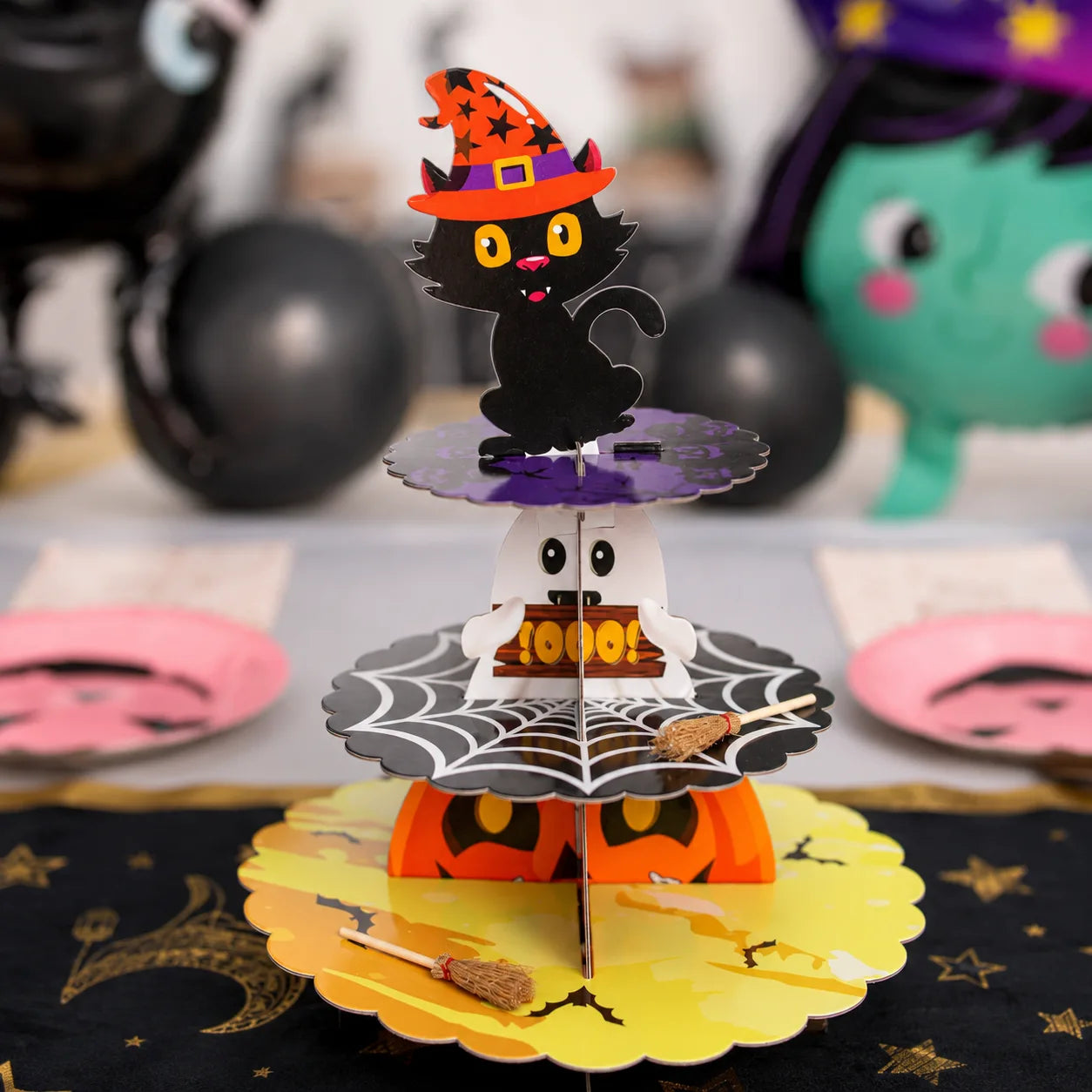 Halloween black cat pumpkin cupcake stand with ghost, spider web and mini witch broom details for a little witch birthday party