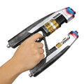 A hand holds a non-firing dual-barrel sci-fi blaster prop, showing the twin barrels, black grip and silver and gold painted details.