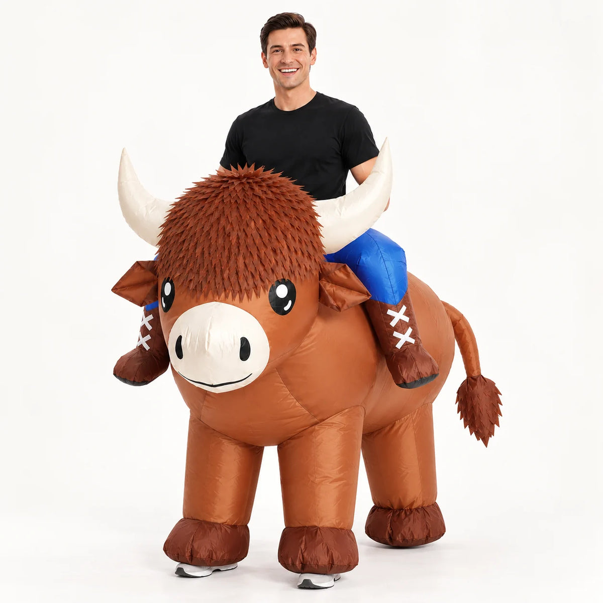 Adult wearing a brown Highland cow ride-on inflatable costume on a white background.