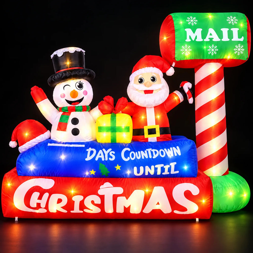 Inflatable Christmas mailbox countdown display illuminated at night with Santa and a snowman.