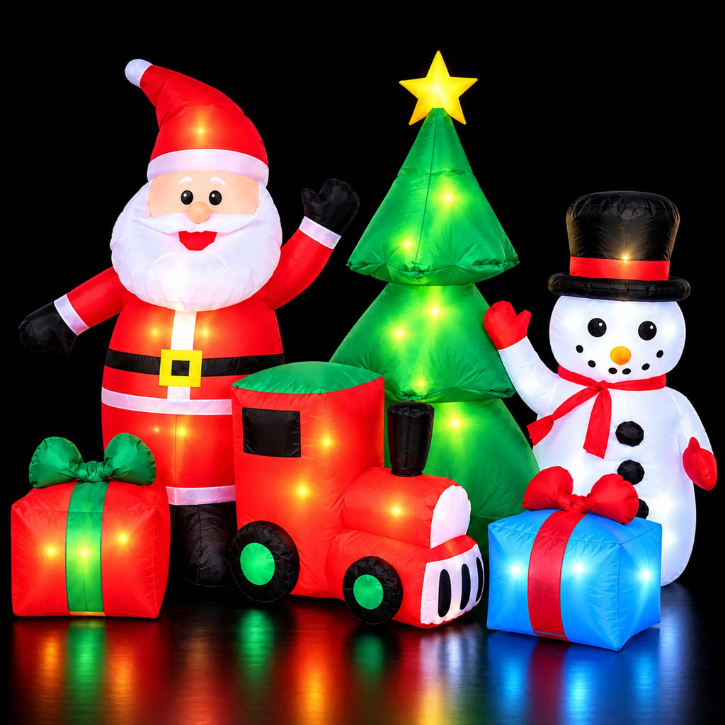 Inflatable Santa, snowman, Christmas tree, train, and gifts illuminated at night.