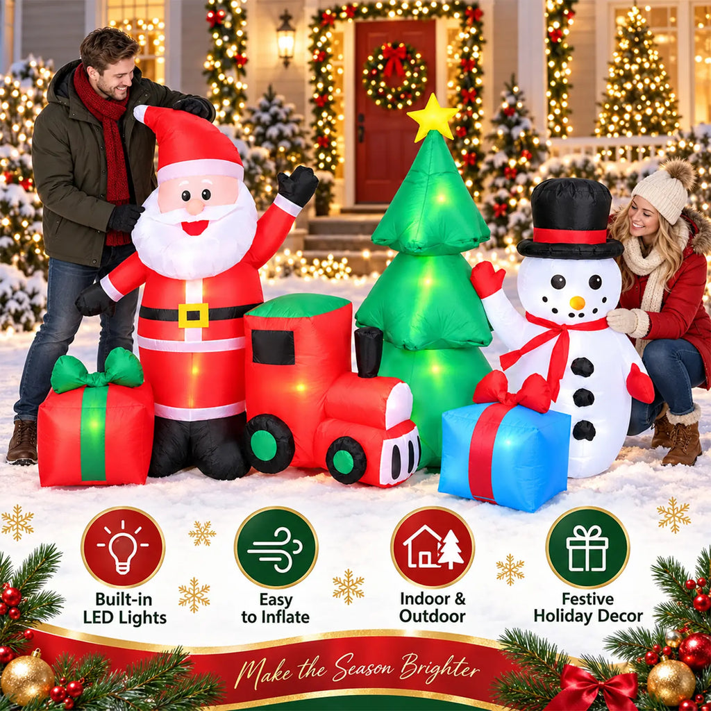 Inflatable Christmas yard display with Santa, snowman, tree, train, and gifts beside a decorated home.