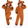 Two children wear matching brown capybara costume onesies together indoors