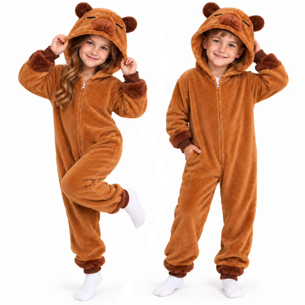 Two children wear matching brown capybara costume onesies together indoors
